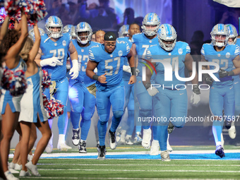 Detroit Lions players run onto the field ahead of an NFL  football game between the Detroit Lions and the Chicago Bears in Detroit, Michigan...