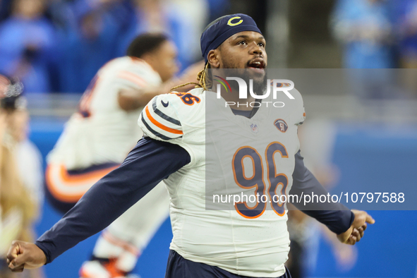 Chicago Bears defensive tackle Zacch Pickens (96) stretches ahead of an NFL  football game between the Detroit Lions and the Chicago Bears i...