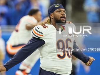 Chicago Bears defensive tackle Zacch Pickens (96) stretches ahead of an NFL  football game between the Detroit Lions and the Chicago Bears i...