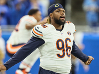 Chicago Bears defensive tackle Zacch Pickens (96) stretches ahead of an NFL  football game between the Detroit Lions and the Chicago Bears i...