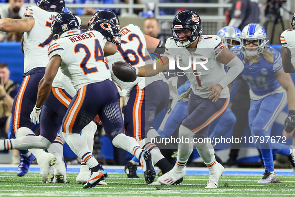 Chicago Bears quarterback Justin Fields (1) fakes a handoff to Chicago Bears running back Khalil Herbert (24) during  an NFL  football game...