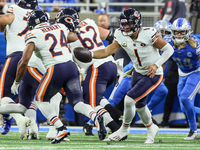 Chicago Bears quarterback Justin Fields (1) fakes a handoff to Chicago Bears running back Khalil Herbert (24) during  an NFL  football game...