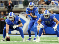 Detroit Lions quarterback Jared Goff (16) prepares to catch the snap from Detroit Lions center Frank Ragnow (77) during  an NFL football gam...