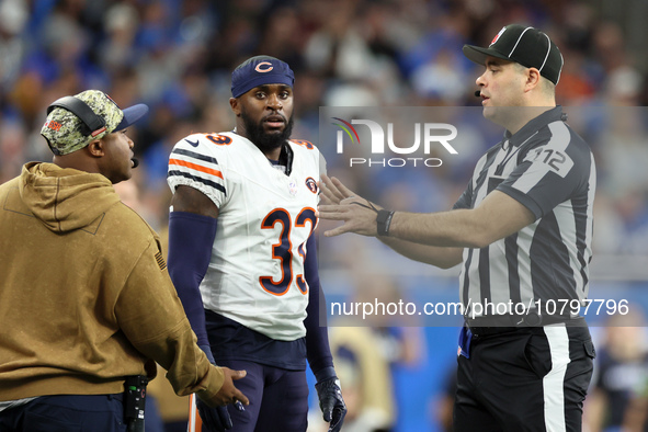 Chicago Bears cornerback Jaylon Johnson (33) discusses a call with down judge Brian Sakowski (112) during  an NFL  football game between the...