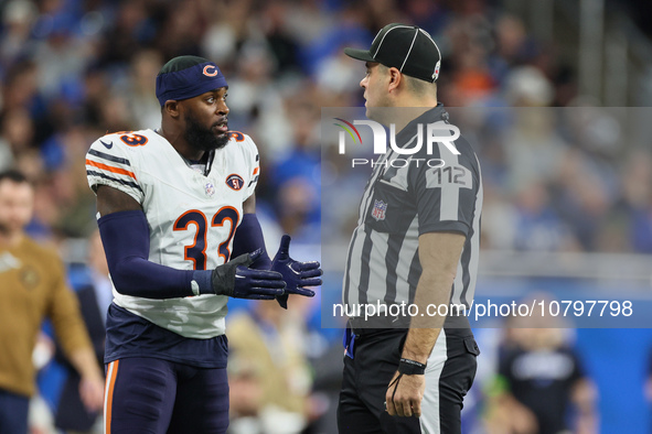 Chicago Bears cornerback Jaylon Johnson (33) discusses a call with down judge Brian Sakowski (112) during  an NFL  football game between the...