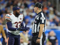 Chicago Bears cornerback Jaylon Johnson (33) discusses a call with down judge Brian Sakowski (112) during  an NFL  football game between the...