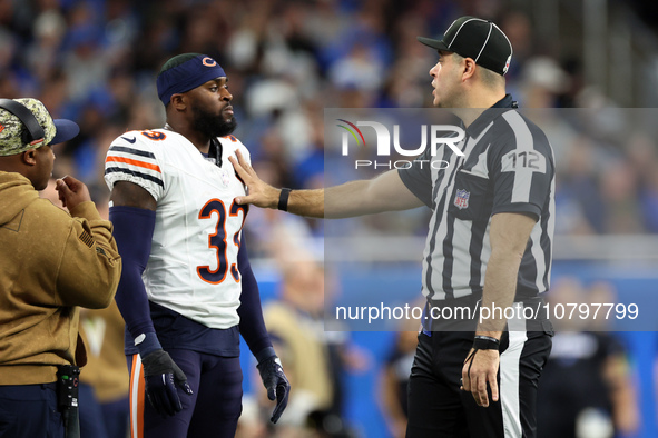 Chicago Bears cornerback Jaylon Johnson (33) discusses a call with down judge Brian Sakowski (112) during  an NFL  football game between the...