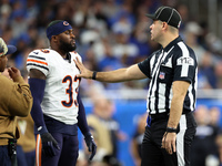 Chicago Bears cornerback Jaylon Johnson (33) discusses a call with down judge Brian Sakowski (112) during  an NFL  football game between the...