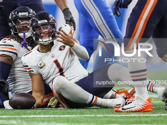 Chicago Bears quarterback Justin Fields (1) reacts after being sacked by Detroit Lions linebacker Alex Anzalone (34) during  an NFL  footbal...