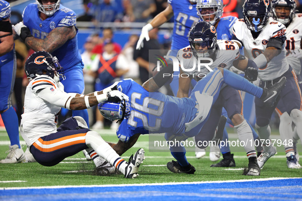 Detroit Lions running back Jahmyr Gibbs (26) is tackled by Chicago Bears safety Eddie Jackson (4) during the second half of an NFL football...