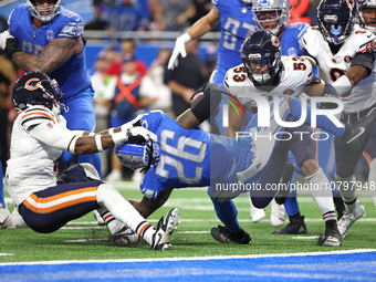 Detroit Lions running back Jahmyr Gibbs (26) is tackled by Chicago Bears safety Eddie Jackson (4) during the second half of an NFL football...