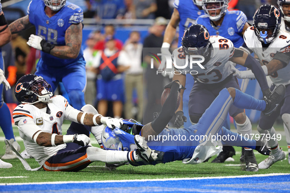 Detroit Lions running back Jahmyr Gibbs (26) is tackled by Chicago Bears safety Eddie Jackson (4) during the second half of an NFL football...