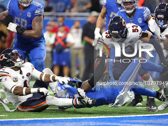 Detroit Lions running back Jahmyr Gibbs (26) is tackled by Chicago Bears safety Eddie Jackson (4) during the second half of an NFL football...