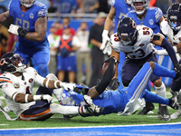 Detroit Lions running back Jahmyr Gibbs (26) is tackled by Chicago Bears safety Eddie Jackson (4) during the second half of an NFL football...