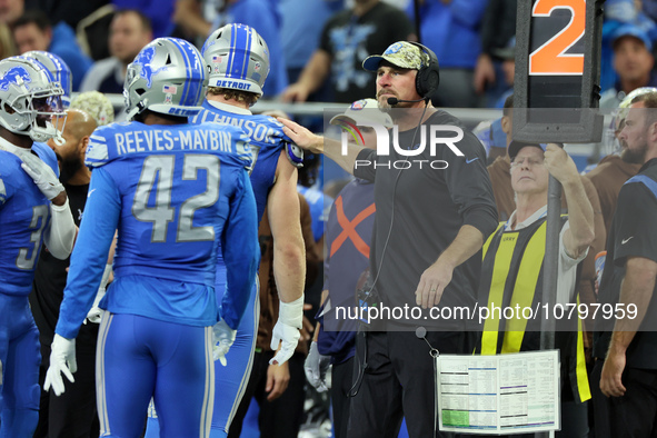 Detroit Lions head coach Dan Campbell congratulates Detroit Lions defensive end Aidan Hutchinson (97) after a play during  an NFL  football...