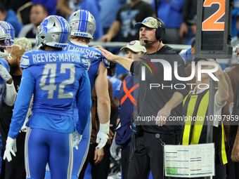 Detroit Lions head coach Dan Campbell congratulates Detroit Lions defensive end Aidan Hutchinson (97) after a play during  an NFL  football...