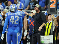 Detroit Lions head coach Dan Campbell congratulates Detroit Lions defensive end Aidan Hutchinson (97) after a play during  an NFL  football...