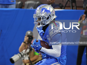 Detroit Lions wide receiver Jameson Williams (9) catches a pass for a touchdown during the second half of an NFL football game between the C...