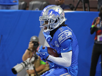 Detroit Lions wide receiver Jameson Williams (9) catches a pass for a touchdown during the second half of an NFL football game between the C...