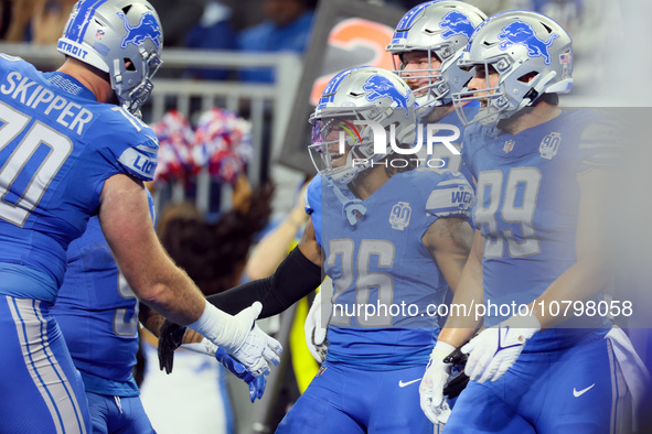 Detroit Lions running back Jahmyr Gibbs (26) is congratulated by his teammates after making a touchdown during  an NFL  football game betwee...