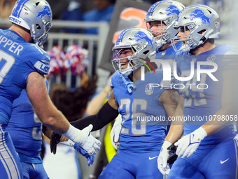 Detroit Lions running back Jahmyr Gibbs (26) is congratulated by his teammates after making a touchdown during  an NFL  football game betwee...