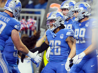 Detroit Lions running back Jahmyr Gibbs (26) is congratulated by his teammates after making a touchdown during  an NFL  football game betwee...