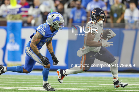 Chicago Bears running back Khalil Herbert (24) carries the ball under the pressure of Detroit Lions safety Brian Branch (32) during  an NFL...