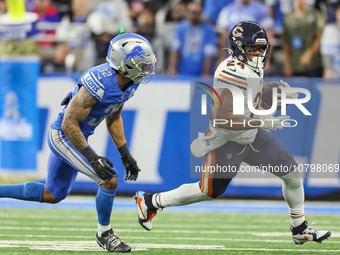 Chicago Bears running back Khalil Herbert (24) carries the ball under the pressure of Detroit Lions safety Brian Branch (32) during  an NFL...