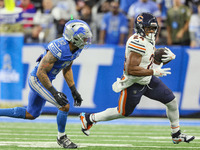 Chicago Bears running back Khalil Herbert (24) carries the ball under the pressure of Detroit Lions safety Brian Branch (32) during  an NFL...