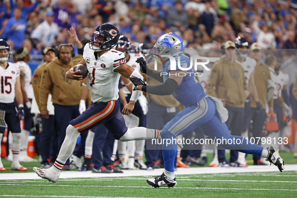 Chicago Bears quarterback Justin Fields (1) runs the ball against Detroit Lions linebacker Derrick Barnes (55) during the second half of an...