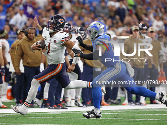 Chicago Bears quarterback Justin Fields (1) runs the ball against Detroit Lions linebacker Derrick Barnes (55) during the second half of an...