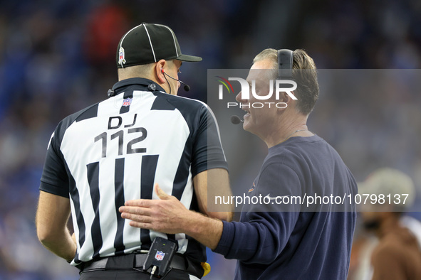 Chicago Bears head coach Matt Eberflus talks with down judge Brian Sakowski during  an NFL  football game between the Detroit Lions and the...