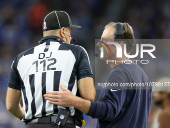 Chicago Bears head coach Matt Eberflus talks with down judge Brian Sakowski during  an NFL  football game between the Detroit Lions and the...