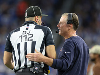 Chicago Bears head coach Matt Eberflus talks with down judge Brian Sakowski during  an NFL  football game between the Detroit Lions and the...