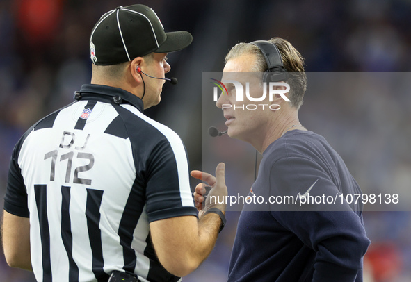 Chicago Bears head coach Matt Eberflus talks with down judge Brian Sakowski during  an NFL  football game between the Detroit Lions and the...