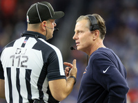 Chicago Bears head coach Matt Eberflus talks with down judge Brian Sakowski during  an NFL  football game between the Detroit Lions and the...