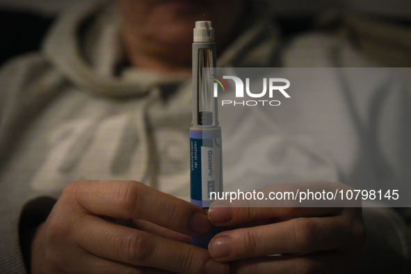 A woman holds an Ozempic needle shot pen in this photograph taken in Warsaw, Poland on 19 November, 2023. German regulator BfArM is consider...