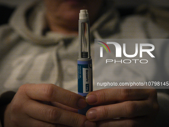 A woman holds an Ozempic needle shot pen in this photograph taken in Warsaw, Poland on 19 November, 2023. German regulator BfArM is consider...