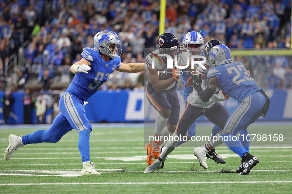 Chicago Bears wide receiver DJ Moore (2) is tackled by Detroit Lions defensive end Aidan Hutchinson (97) during the first half of an NFL foo...