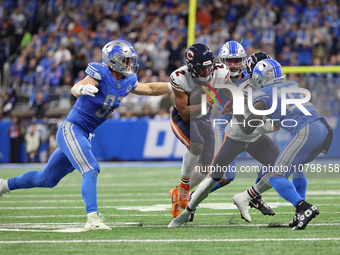 Chicago Bears wide receiver DJ Moore (2) is tackled by Detroit Lions defensive end Aidan Hutchinson (97) during the first half of an NFL foo...