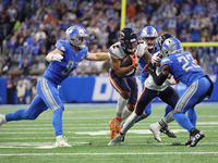 Chicago Bears wide receiver DJ Moore (2) is tackled by Detroit Lions defensive end Aidan Hutchinson (97) during the first half of an NFL foo...