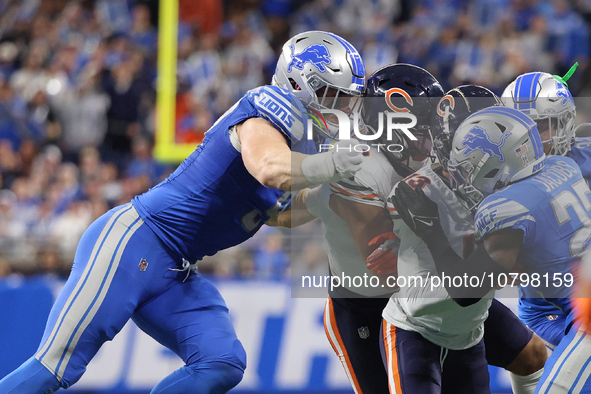 Chicago Bears wide receiver DJ Moore (2) is tackled by Detroit Lions defensive end Aidan Hutchinson (97) during the first half of an NFL foo...