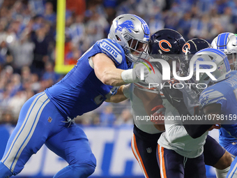 Chicago Bears wide receiver DJ Moore (2) is tackled by Detroit Lions defensive end Aidan Hutchinson (97) during the first half of an NFL foo...