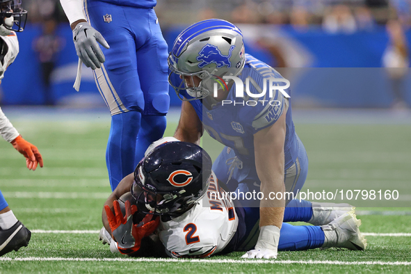 Chicago Bears wide receiver DJ Moore (2) is tackled by Detroit Lions defensive end Aidan Hutchinson (97) during the first half of an NFL foo...