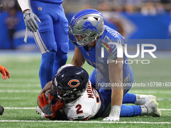 Chicago Bears wide receiver DJ Moore (2) is tackled by Detroit Lions defensive end Aidan Hutchinson (97) during the first half of an NFL foo...