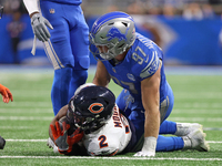 Chicago Bears wide receiver DJ Moore (2) is tackled by Detroit Lions defensive end Aidan Hutchinson (97) during the first half of an NFL foo...