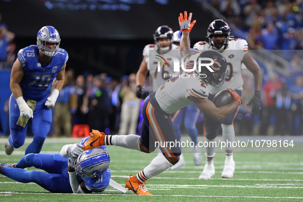 Chicago Bears wide receiver DJ Moore (2) runs the ball against Detroit Lions safety Kerby Joseph (31) during the first half of an NFL footba...