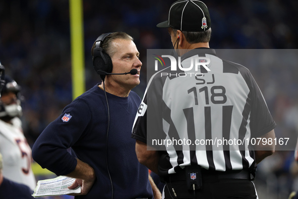 Chicago Bears head coach Matt Eberflus talks to side judge David Meslow during the first half of an NFL football game between the Chicago Be...