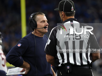 Chicago Bears head coach Matt Eberflus talks to side judge David Meslow during the first half of an NFL football game between the Chicago Be...