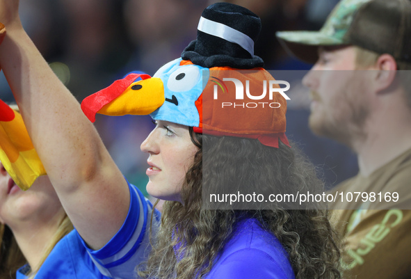 A fan wearing a turkey hat looks onto the field from the stands during  an NFL  football game between the Detroit Lions and the Chicago Bear...